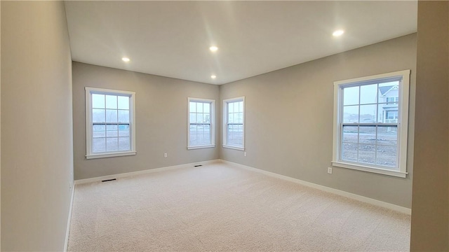 unfurnished room with light carpet