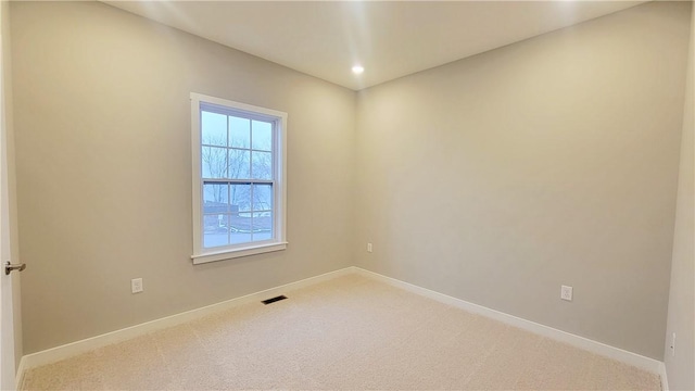 unfurnished room with carpet floors and a healthy amount of sunlight