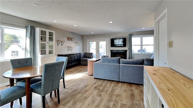 dining space featuring french doors and light hardwood / wood-style floors