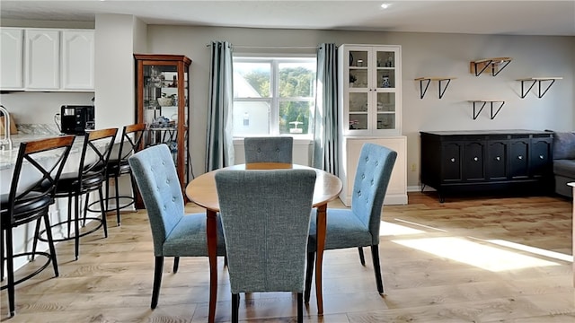 dining area with light hardwood / wood-style floors