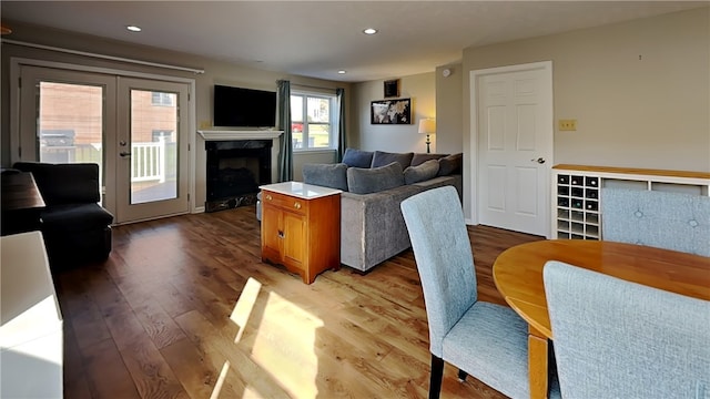 living room with light wood-type flooring and a fireplace