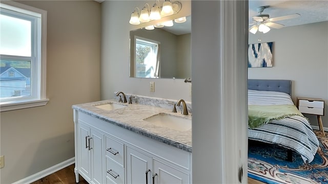 bathroom with ceiling fan, wood-type flooring, and vanity