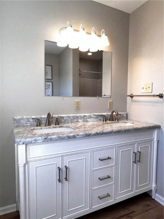 bathroom with hardwood / wood-style floors and vanity