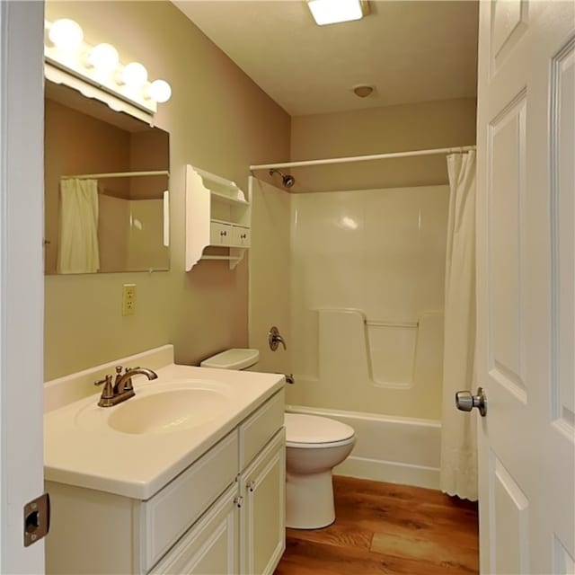 full bathroom featuring vanity, hardwood / wood-style flooring, toilet, and shower / bathtub combination with curtain