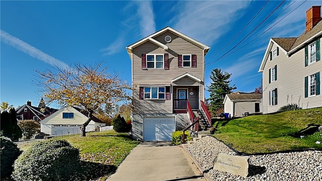 front of property featuring a garage, a front lawn, and an outdoor structure