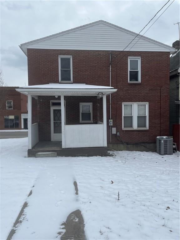 view of front of house with a porch and cooling unit