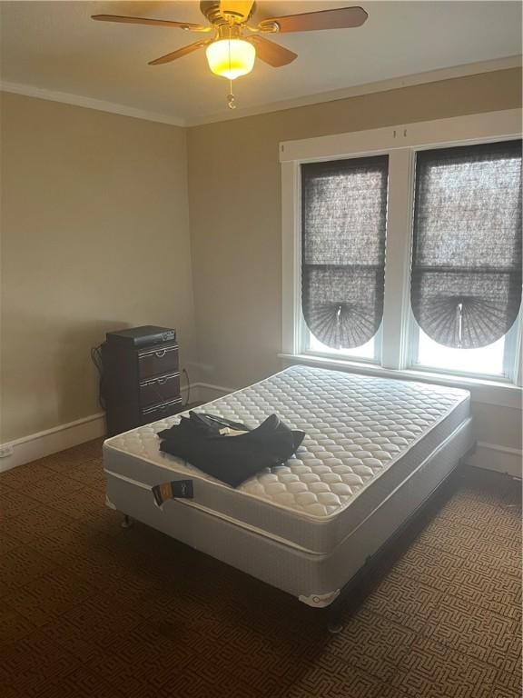 bedroom with ceiling fan and crown molding