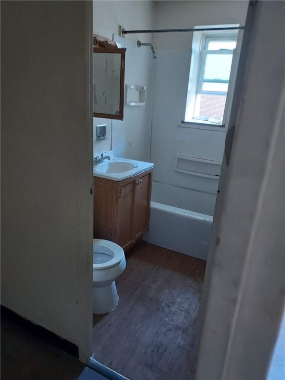 full bathroom featuring wood-type flooring, vanity, bathtub / shower combination, and toilet