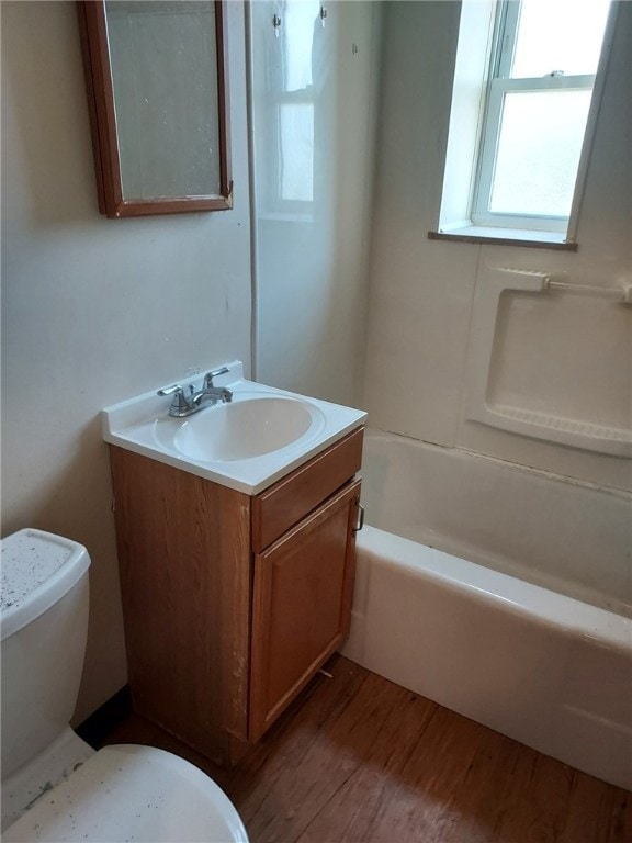 bathroom featuring wood-type flooring, vanity, and toilet