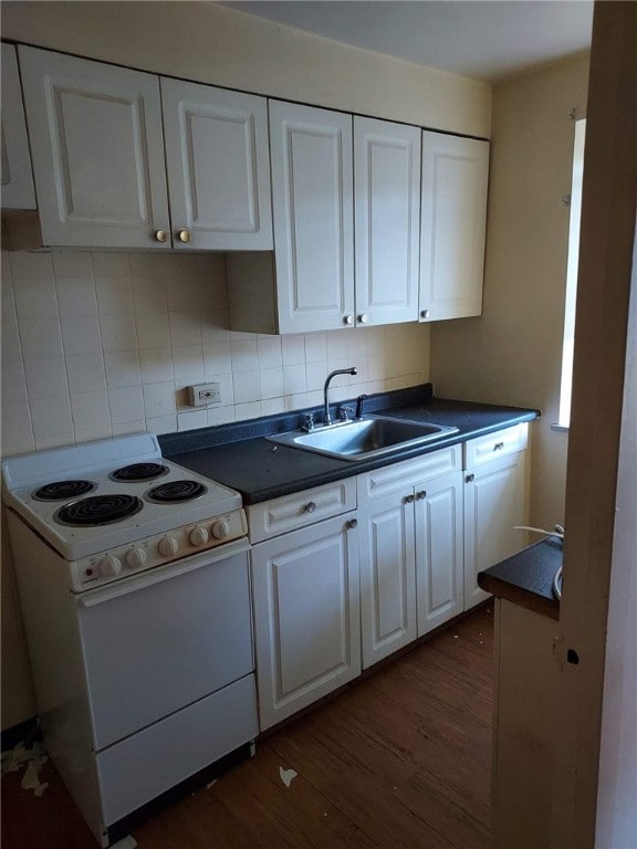 kitchen with decorative backsplash, white cabinets, dark hardwood / wood-style flooring, white range with electric cooktop, and sink