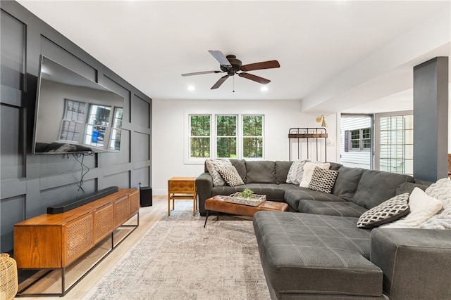 living room featuring light wood-type flooring and ceiling fan