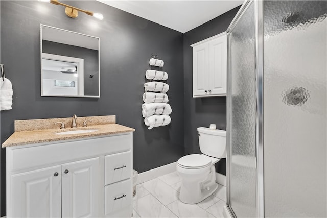 bathroom featuring toilet, vanity, and an enclosed shower