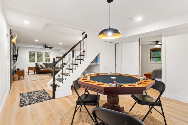 recreation room with light hardwood / wood-style floors and ceiling fan