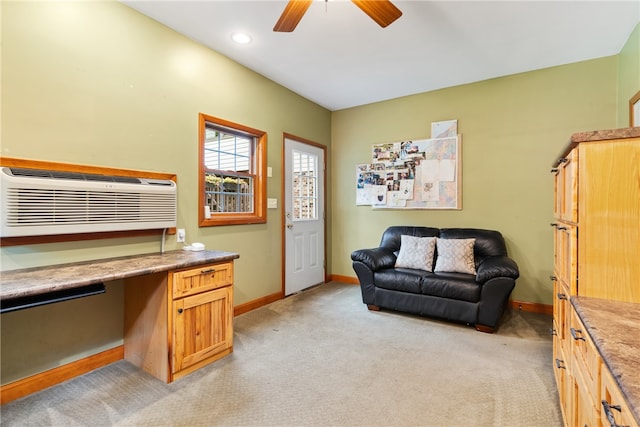 interior space with ceiling fan, built in desk, and a wall mounted AC