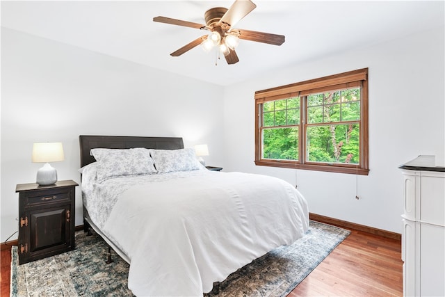 bedroom featuring ceiling fan and light hardwood / wood-style flooring