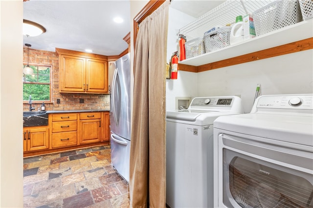 washroom with sink and washer and clothes dryer