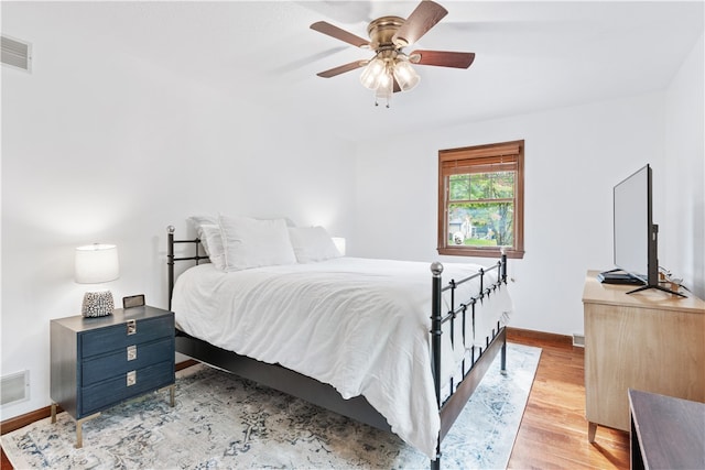 bedroom with light hardwood / wood-style floors and ceiling fan