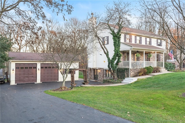 view of front facade featuring a garage, a porch, and a front yard