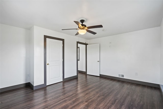 unfurnished bedroom featuring ceiling fan and dark hardwood / wood-style floors