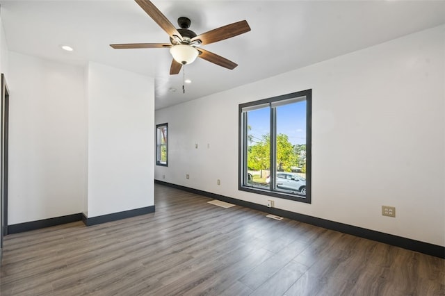 unfurnished room featuring ceiling fan and dark hardwood / wood-style flooring