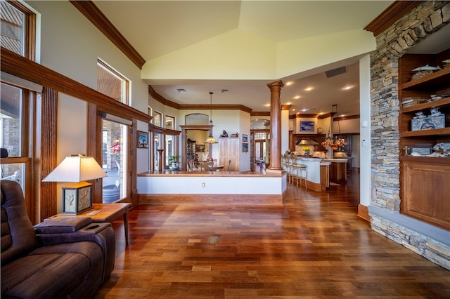 living room featuring ornamental molding, dark hardwood / wood-style flooring, high vaulted ceiling, and ornate columns