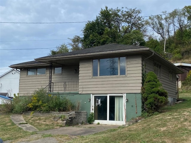 back of house with a lawn