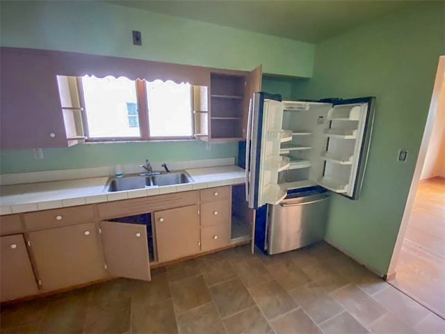 kitchen featuring tile countertops and sink