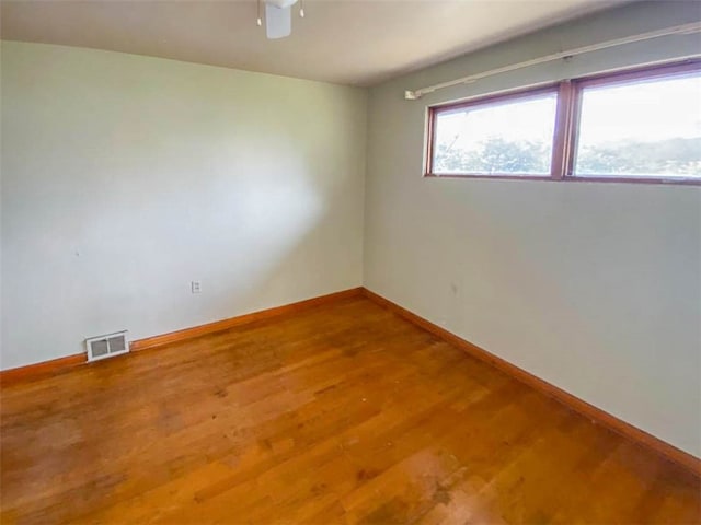 unfurnished room with ceiling fan and hardwood / wood-style floors