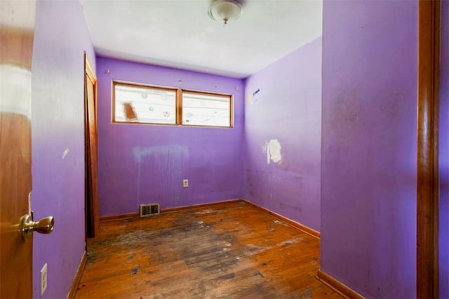 spare room with dark wood-type flooring