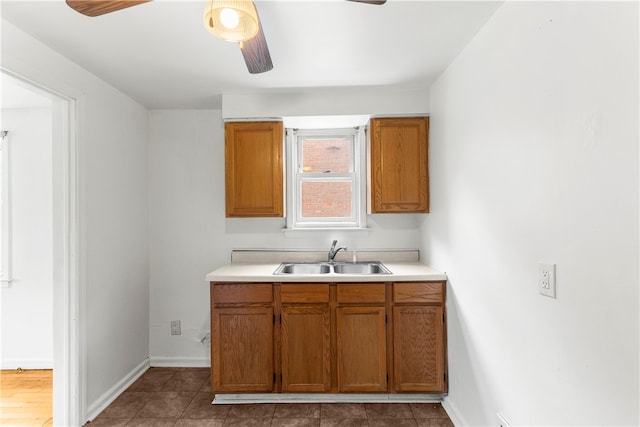 kitchen with ceiling fan, sink, and tile patterned floors