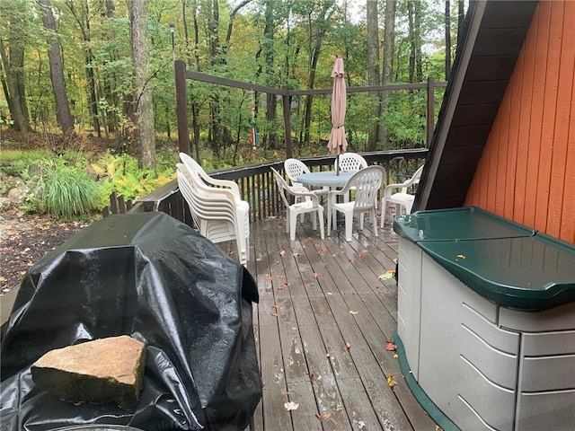 wooden deck featuring a grill