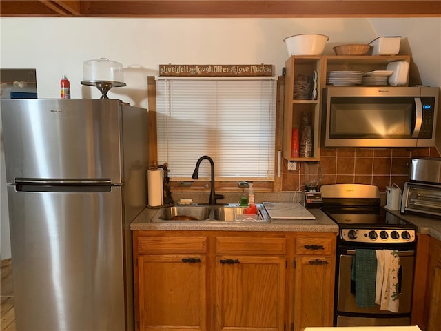 kitchen featuring stainless steel appliances, tasteful backsplash, and sink