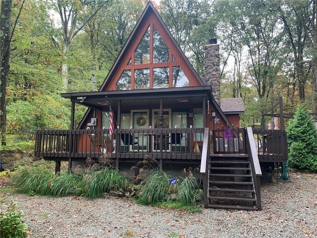 view of front of property with a chimney and a deck