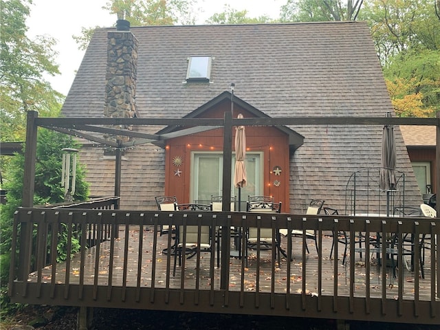 back of property featuring a wooden deck