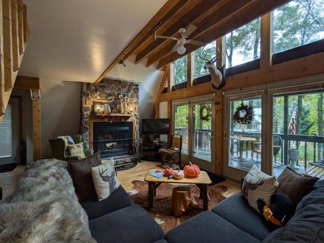 living room with beamed ceiling, hardwood / wood-style floors, ceiling fan, and plenty of natural light