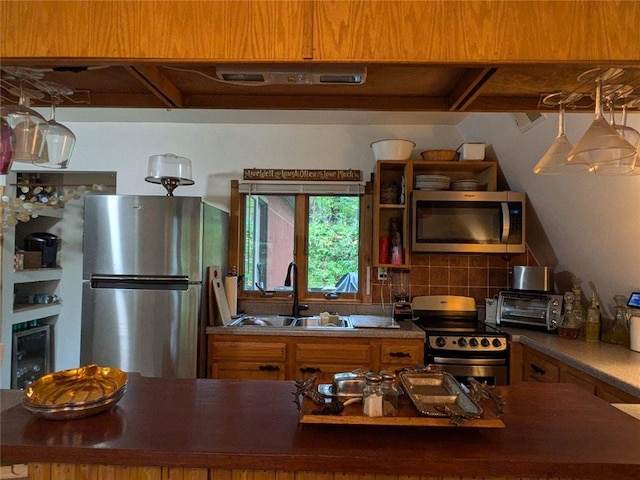 kitchen with backsplash, stainless steel appliances, and sink