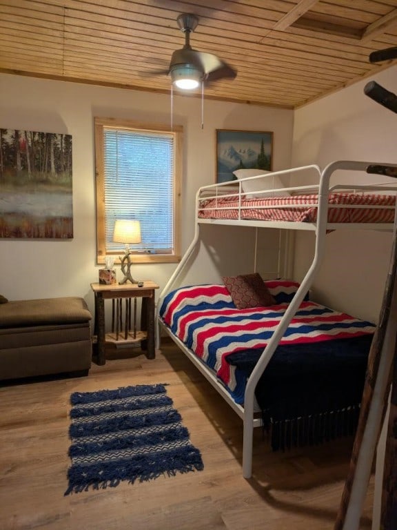 bedroom featuring hardwood / wood-style floors, ceiling fan, and wooden ceiling