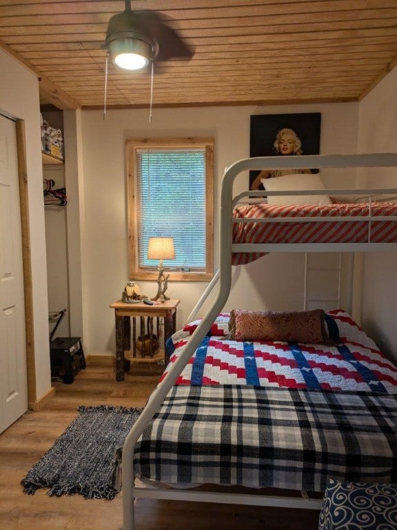 bedroom with ceiling fan, hardwood / wood-style flooring, and wooden ceiling