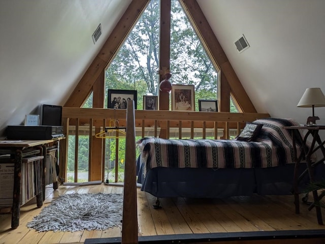 bedroom featuring light hardwood / wood-style floors and high vaulted ceiling