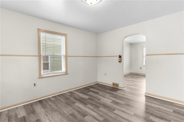 unfurnished room with hardwood / wood-style flooring