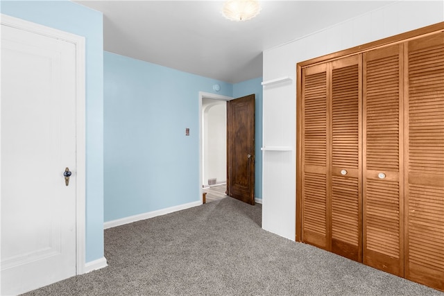 unfurnished bedroom with carpet floors and a closet