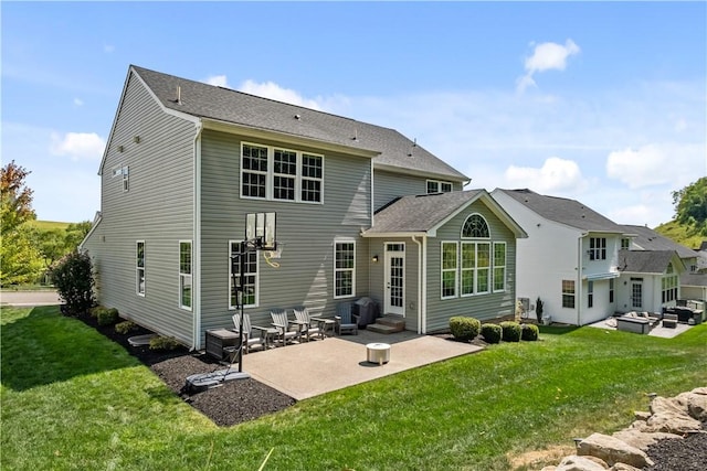 back of property with a lawn and a patio area