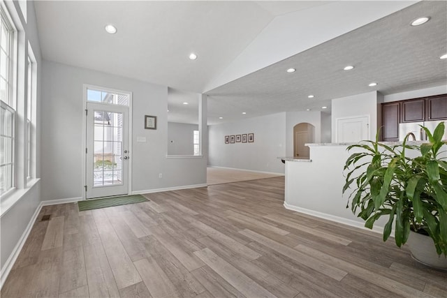 interior space featuring light hardwood / wood-style flooring and lofted ceiling