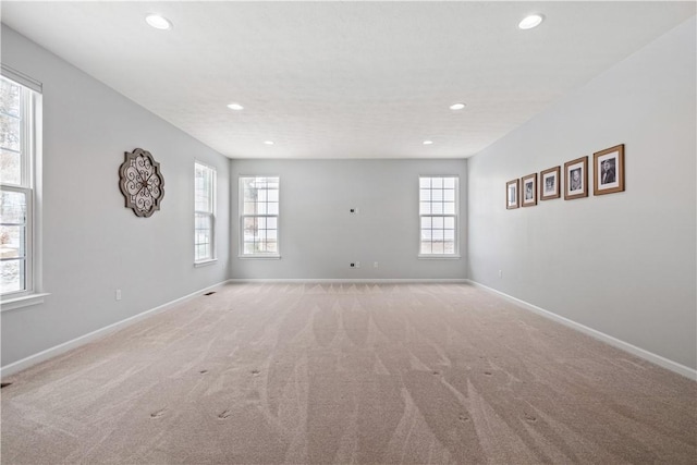 carpeted spare room with a healthy amount of sunlight