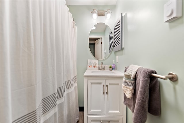 bathroom with walk in shower and vanity