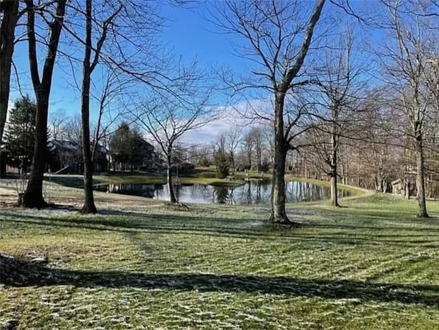 view of community featuring a lawn and a water view