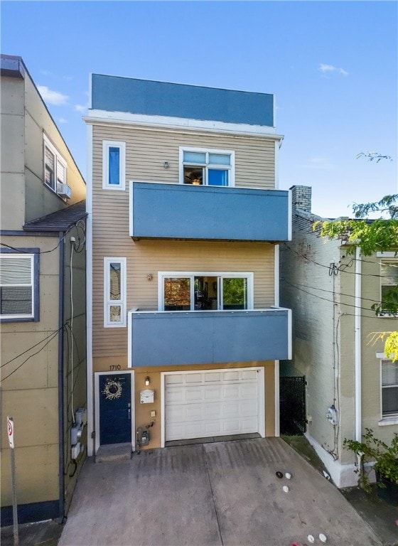 view of front of property featuring a balcony and a garage