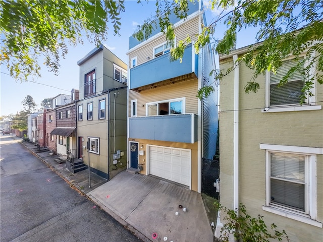 view of front of home featuring a balcony and a garage