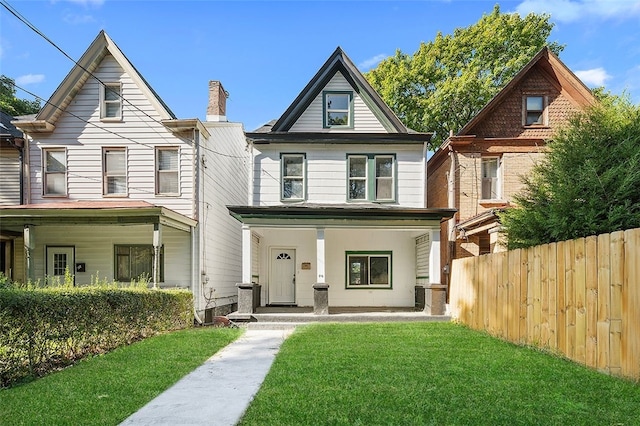 view of front of property with a porch, a front lawn, and central AC unit