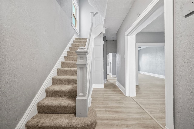 stairs with hardwood / wood-style flooring